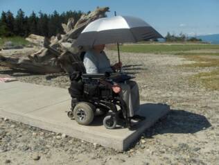 Gerry Price using the umbrella mount looking out at the ocean from Rathtrevor Beach